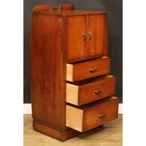 603 - An Art Deco oak and veneer press cupboard, of small proportions, half-gallery above a pair of doors ... 