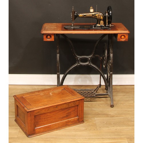 610 - A late 19th century Singer sewing machine, treadle base, 97.5cm high, 81.5cm wide, 41.5cm deep overa... 