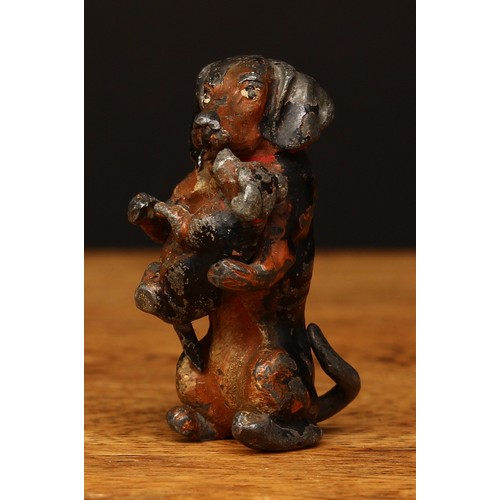 4023A - An early 20th century novelty cold painted lead figure in the form of a black and tan Dachshund crad... 