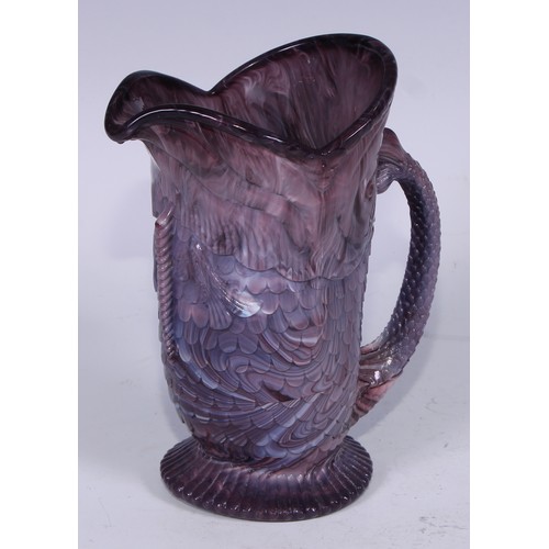 158 - A late 19th century pressed slag glass jug or vase, modelled in the form of a fish, the tail formed ... 