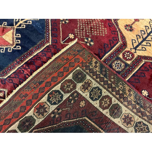 66 - A South-west Persian Lori rug / carpet, hand-knotted in deep shades of burgandy, blue, and cream, 23... 