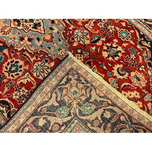 67 - A Najafabad / Najaf-Abad rug / carpet, the central medallion knotted in pale blue, within an intrica... 