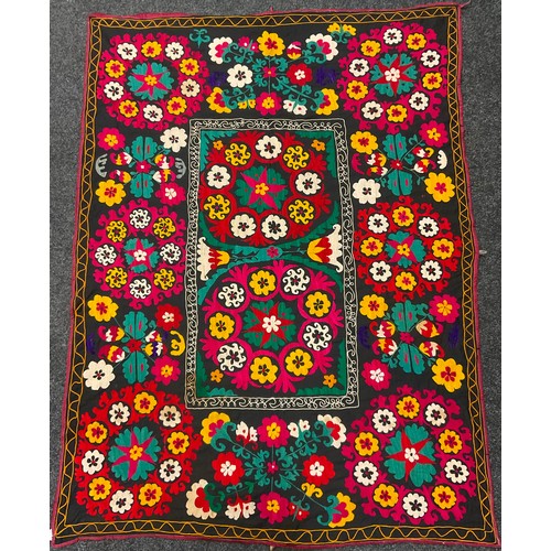 228 - An Uzbek Suzani textile wall-hanging / throw, the bright and colourful Suzan needle-work depicting s... 