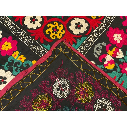 228 - An Uzbek Suzani textile wall-hanging / throw, the bright and colourful Suzan needle-work depicting s... 