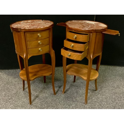 230 - A pair of French mahogany oval bedside tables / cabinets, rouge marble tops, three small drawers to ... 