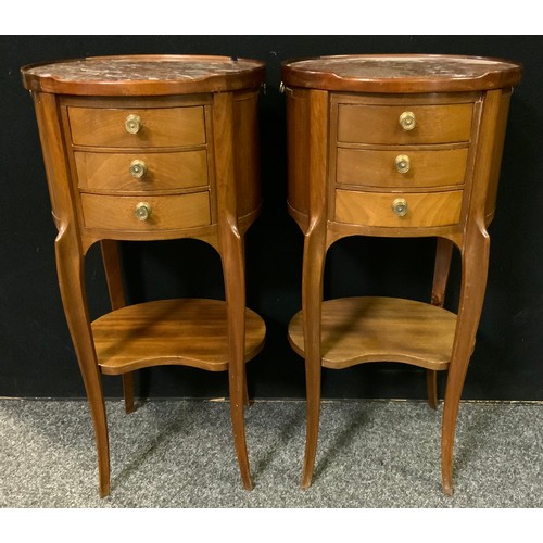 230 - A pair of French mahogany oval bedside tables / cabinets, rouge marble tops, three small drawers to ... 