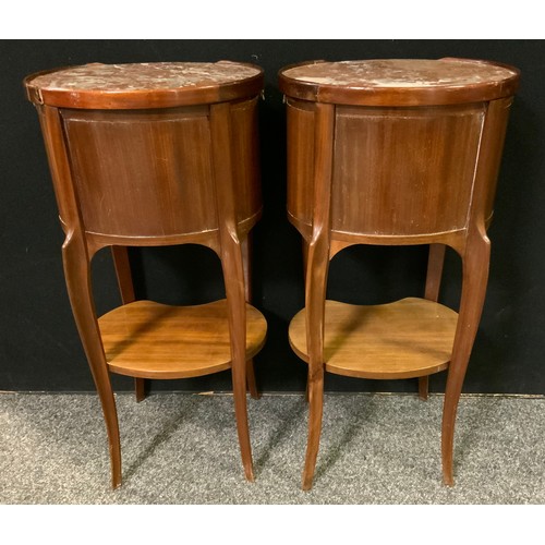 230 - A pair of French mahogany oval bedside tables / cabinets, rouge marble tops, three small drawers to ... 