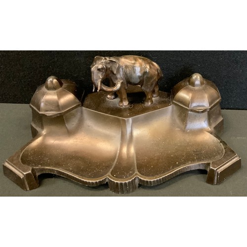 231 - A novelty bronzed metal inkwell, elephant surmount between twin lidded inkwells, shaped pen tray fro... 