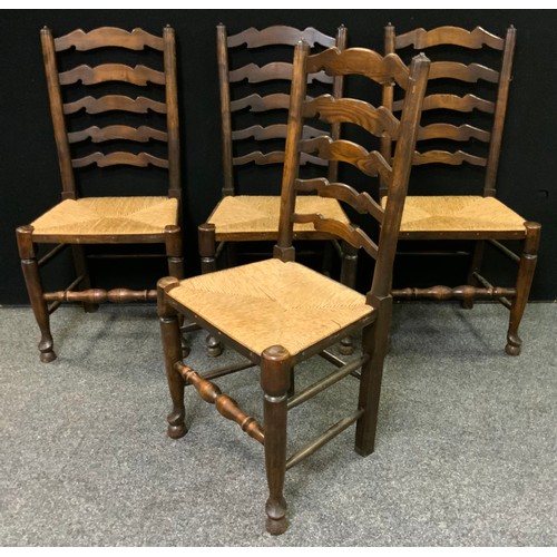 235 - A set of four 19th century ladder-back country house kitchen chairs, rush seats, (4).