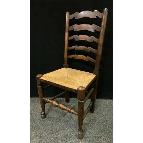 235 - A set of four 19th century ladder-back country house kitchen chairs, rush seats, (4).