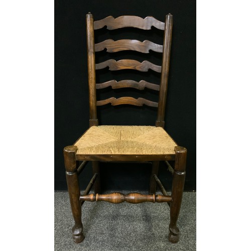 235 - A set of four 19th century ladder-back country house kitchen chairs, rush seats, (4).