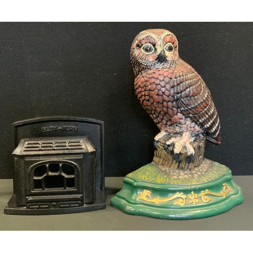 240 - A Wright Studios cast iron door stop, as an Owl, 30cm high, 24.5cm wide;  a Gloworm advertising cast... 