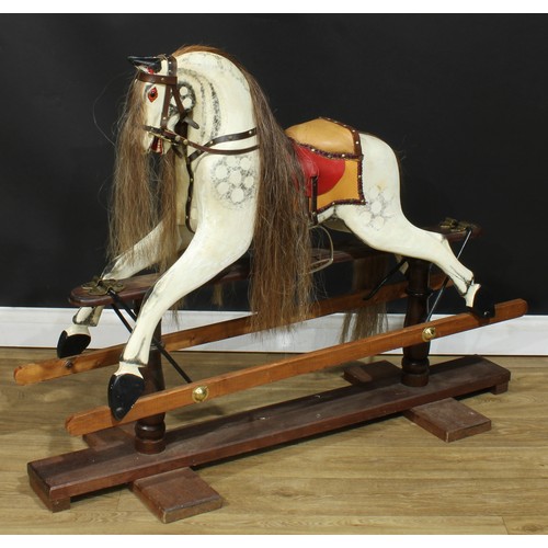 4039 - A 20th century rocking horse on a later replacement safety stand, the carved and later over-painted/... 