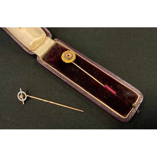 378 - A 15ct gold ruby tie pin, floral top, stamped .625, spiral shaft, 1.2g gross;  another unmarked yell... 