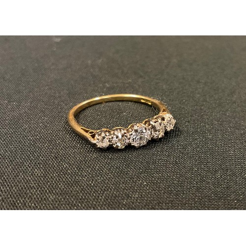 386 - An early 20th century graduated five stone diamond ring, old brilliant cut diamonds ranging from app... 