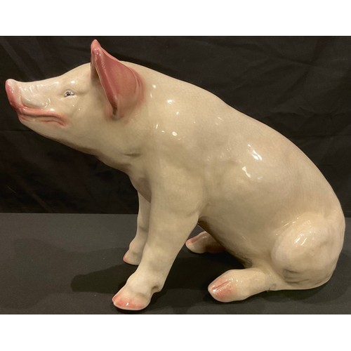 31 - A large pottery model of a pig, possibly butcher's shop display, 34cm high