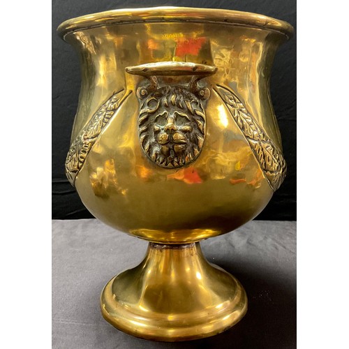 53 - An 19th century French brass pedestal wine cooler, hammered decoration of swags and crests, lion mas... 