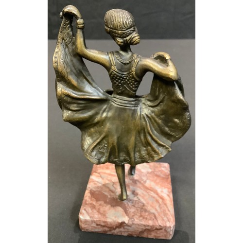 61 - After Bergman, a bronzed figure of an exotic dancer, her skirt lifting to reveal a nude, marble base... 