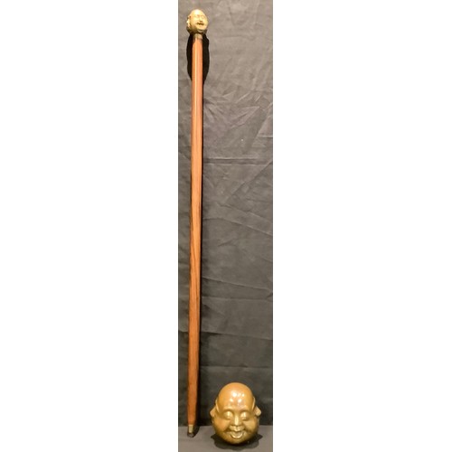 63 - A bronzed metal four faced Buddha, 11cm high; a walking stick, the handle modelled as a four faced B... 