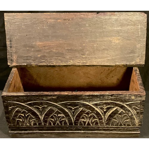 92 - An 18th century carved oak candle box, hinged cover, later replacement base, 33cm wide