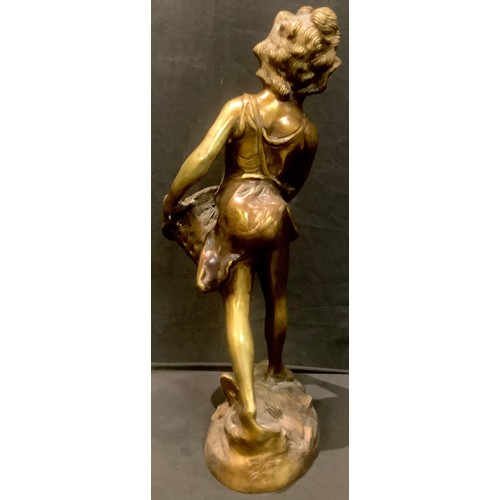 95 - A bronzed metal sculpture of a girl with basket, 43cm high