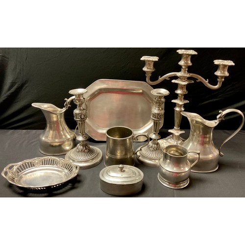 129 - An EPNS two branch candelabra; a continental pewter mug; a pair of continental Zinh pewter alloy jug... 