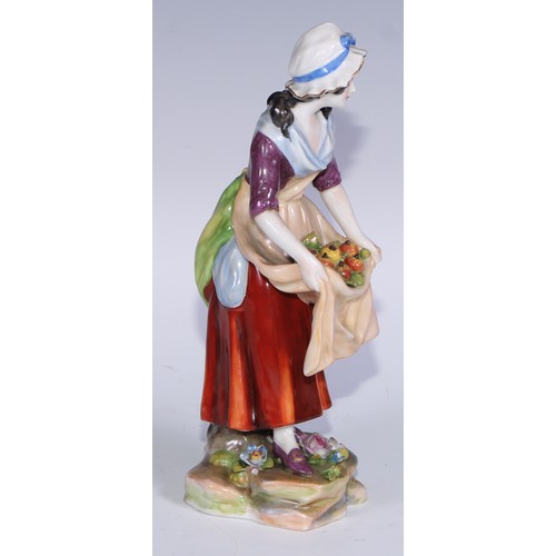 741 - A pair of Continental porcelain figures, fruit sellers, in the 18th century taste, 20.5cm high, blue... 