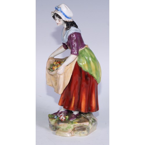 741 - A pair of Continental porcelain figures, fruit sellers, in the 18th century taste, 20.5cm high, blue... 