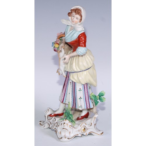 741 - A pair of Continental porcelain figures, fruit sellers, in the 18th century taste, 20.5cm high, blue... 