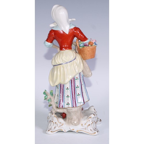 741 - A pair of Continental porcelain figures, fruit sellers, in the 18th century taste, 20.5cm high, blue... 