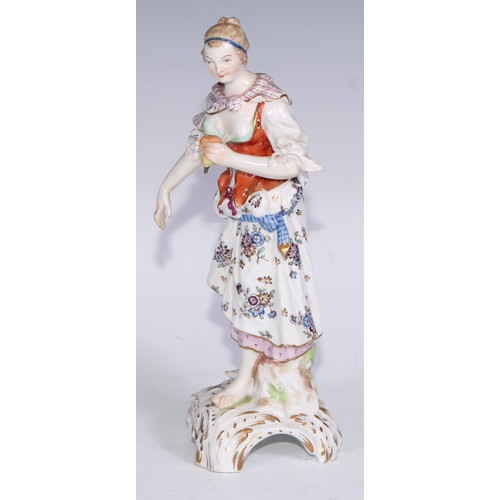 741 - A pair of Continental porcelain figures, fruit sellers, in the 18th century taste, 20.5cm high, blue... 