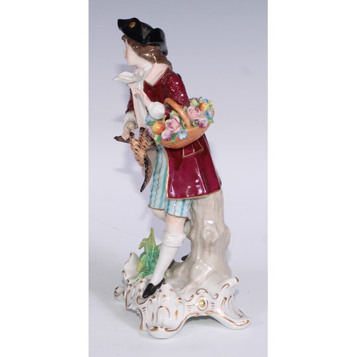 741 - A pair of Continental porcelain figures, fruit sellers, in the 18th century taste, 20.5cm high, blue... 