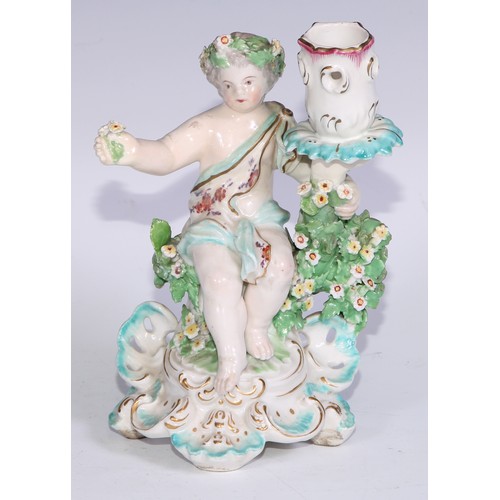 690 - A Derby patch mark figural candlestick, modelled as Cupid kneeling before bocage, scroll and shell b... 