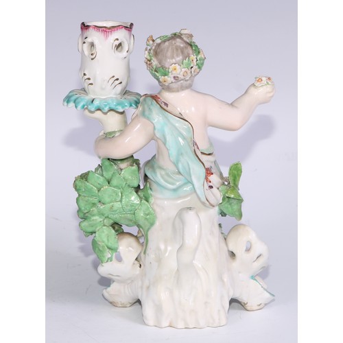 690 - A Derby patch mark figural candlestick, modelled as Cupid kneeling before bocage, scroll and shell b... 