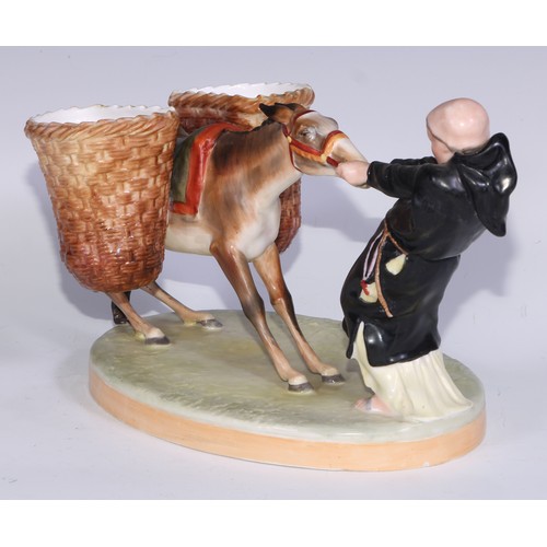 591 - A Derby Crown Porcelain figural sweetmeat stand, modelled as a friar and donkey, 28cm long, printed ... 