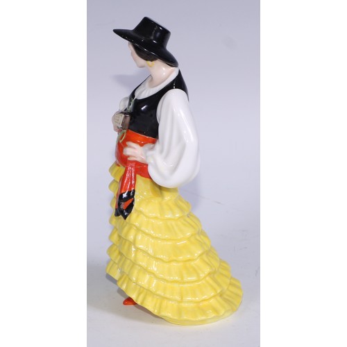 636 - A Royal Crown Derby figure, Spanish Duet, he stands wearing a black hat and and long cape, holding a... 