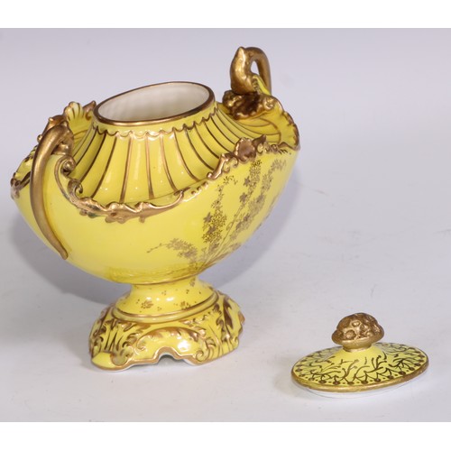 656 - A Royal Crown Derby two-handled boat shaped pedestal vase, moulded and decorated in gilt on a yellow... 