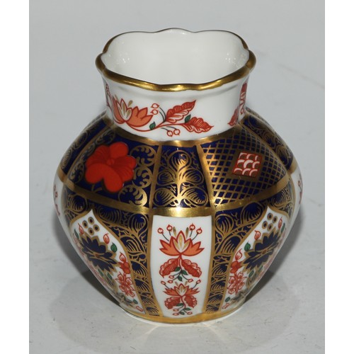 617 - A Royal Crown Derby 1128 pattern table cigarette lighter, 8.5cm diam, printed mark; another; a pair ... 