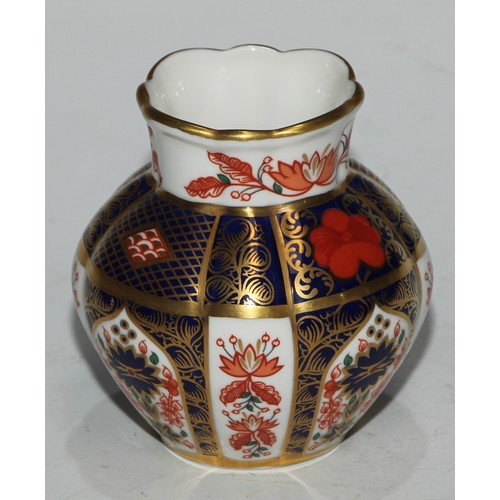 617 - A Royal Crown Derby 1128 pattern table cigarette lighter, 8.5cm diam, printed mark; another; a pair ... 