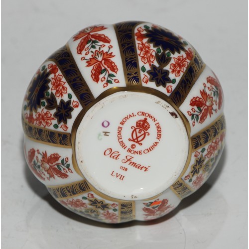 617 - A Royal Crown Derby 1128 pattern table cigarette lighter, 8.5cm diam, printed mark; another; a pair ... 