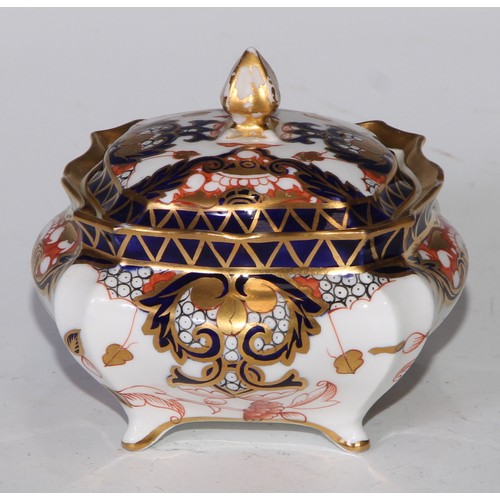 605 - A pair of Royal Crown Derby Imari square bombe shaped boxes and covers, 8cm wide, printed marks; ano... 