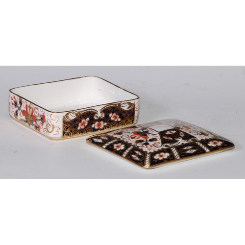 605 - A pair of Royal Crown Derby Imari square bombe shaped boxes and covers, 8cm wide, printed marks; ano... 