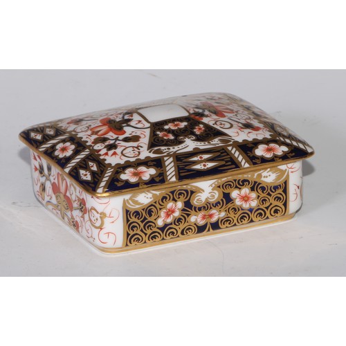 605 - A pair of Royal Crown Derby Imari square bombe shaped boxes and covers, 8cm wide, printed marks; ano... 