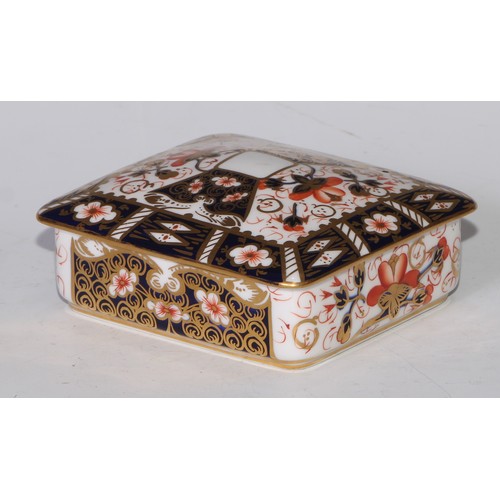 605 - A pair of Royal Crown Derby Imari square bombe shaped boxes and covers, 8cm wide, printed marks; ano... 