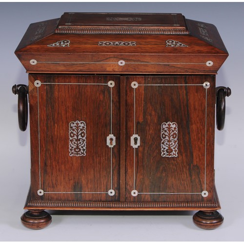 387 - A George IV rosewood and mother of pearl sarcophagus table cabinet, hinged cover above a pair of doo... 