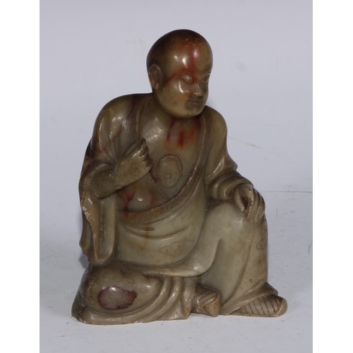 382 - A Chinese soapstone figure, of a monk, seated, parting his robe, Buddha displayed on his chest, 12.5... 