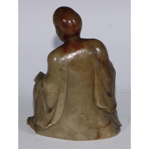 382 - A Chinese soapstone figure, of a monk, seated, parting his robe, Buddha displayed on his chest, 12.5... 