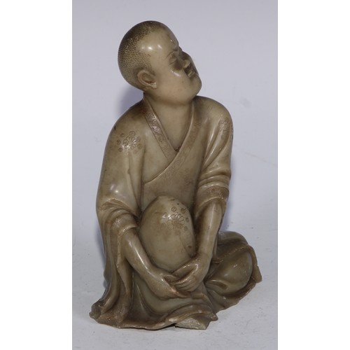 382 - A Chinese soapstone figure, of a monk, seated, parting his robe, Buddha displayed on his chest, 12.5... 