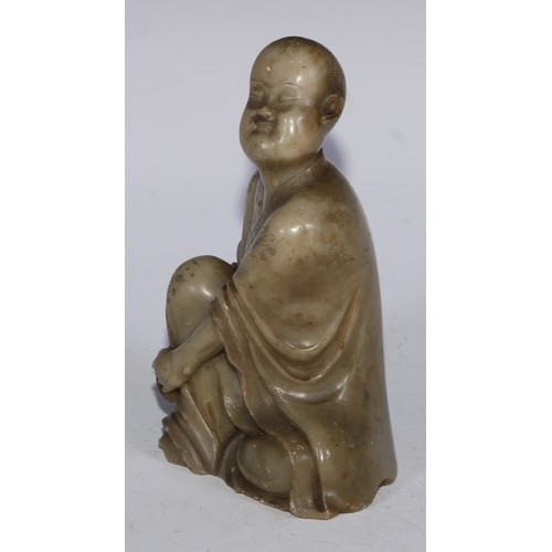 382 - A Chinese soapstone figure, of a monk, seated, parting his robe, Buddha displayed on his chest, 12.5... 