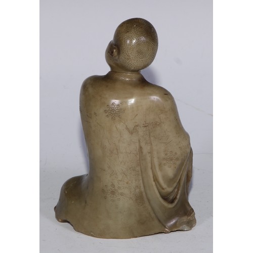 382 - A Chinese soapstone figure, of a monk, seated, parting his robe, Buddha displayed on his chest, 12.5... 